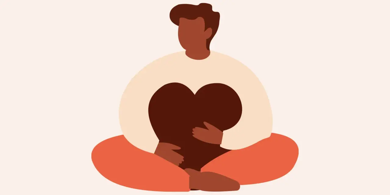 En person sitter i meditationsställning och håller ett hjärta. Detta illustrerar vad betyder mindfulness – att vara närvarande och omfamna sina känslor.