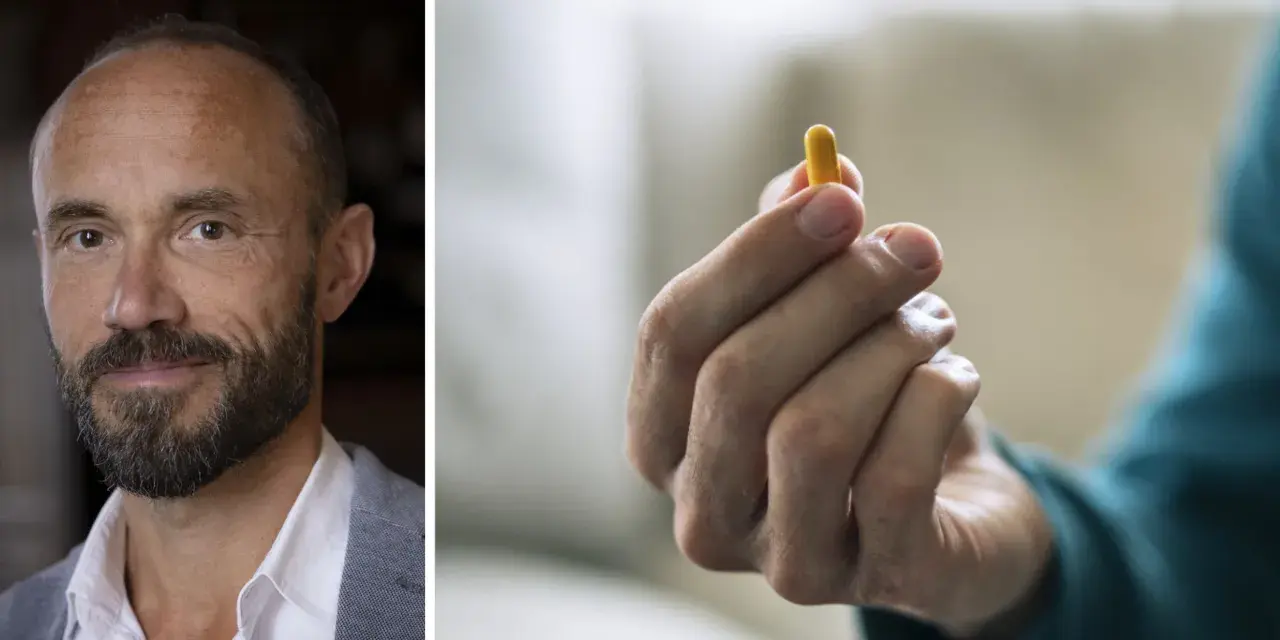Man med skägg och en gul kapsel i handen. Kanske en illustration till vad betyder psykos.