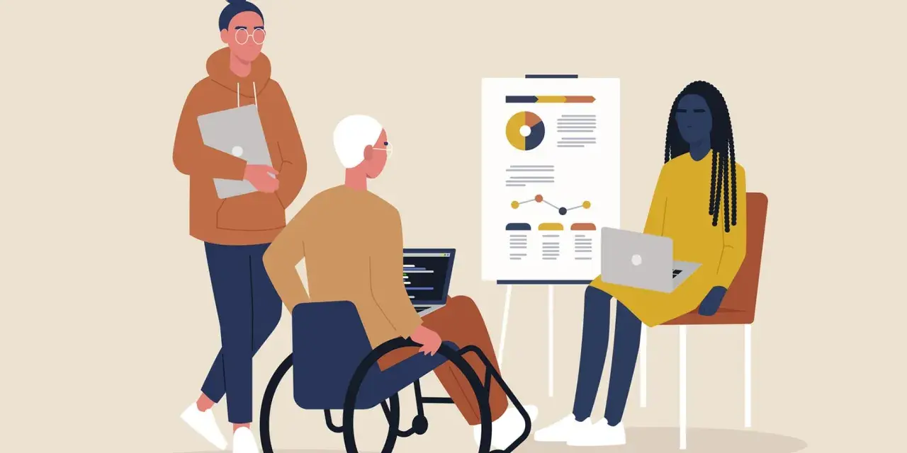 Tre personer vid ett möte. En i rullstol, en med laptop och en med en annan laptop. Känslan av psykisk misshandel på jobbet kan uppstå i sådana situationer.