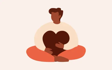 En person sitter i meditationsställning och håller ett hjärta. Detta illustrerar vad betyder mindfulness – att vara närvarande och omfamna sina känslor.