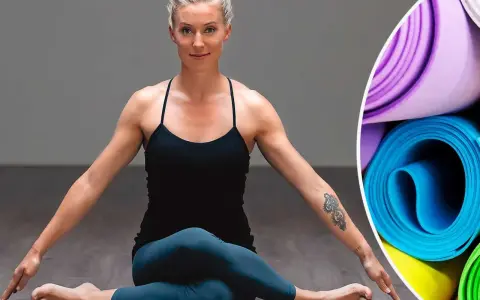 Kvinna i yogaposition, redo för liggande meditation. Rullade yogamattor i bakgrunden.
