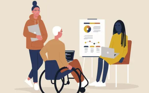 Tre personer vid ett möte. En i rullstol, en med laptop och en med en annan laptop. Känslan av psykisk misshandel på jobbet kan uppstå i sådana situationer.
