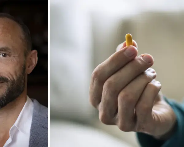 Man med skägg och en gul kapsel i handen. Kanske en illustration till vad betyder psykos.