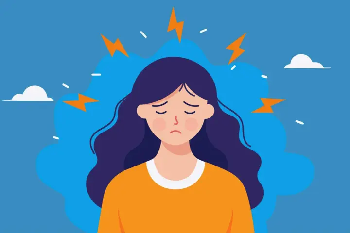 En person med mörkt hår och en orange tröja känner inre stress symptom, symboliserat av blixtar runt huvudet.