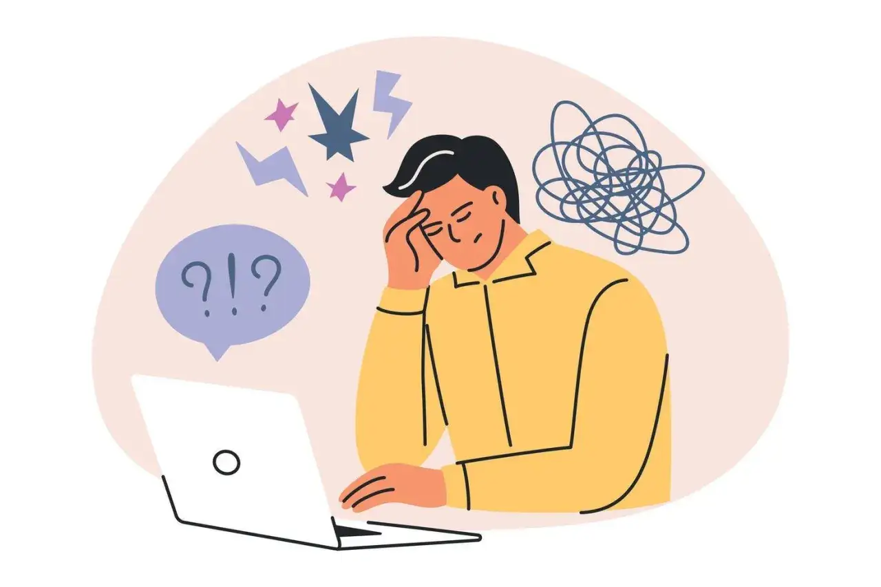 En person med stress och &aring;ngest sitter vid en laptop, med huvudet i handen och tankar som virvlar runt.