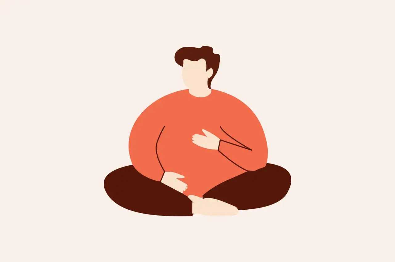 En person sitter i lotusst&auml;llning, med h&auml;nderna p&aring; magen, en bild som kan symbolisera stark oro.